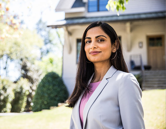 Membership - real estate professional in front of a house