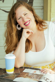 Photo of Lia Picard sitting at a table, smiling