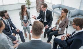 Board members sitting in a circle in a meeting 