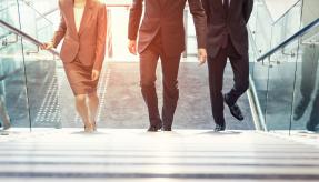 Business men and woman climbing stairs abstract