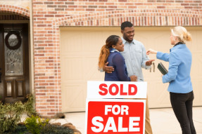 Couple receives keys to first home real estate purchase.