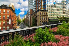 View of downtown skyscrapers, commercial buildings, public transportation and a park