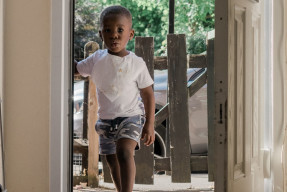 Black child entering a home