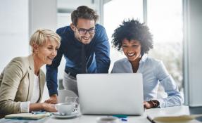 A group of businesspeople working together on a laptop