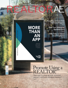 Cover of REALTOR® AE Fall Magazine with the slogo More Than An App on a billboard on a sidewalk