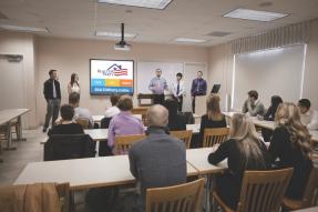 Attendees watching an RPAC presentation on a screen