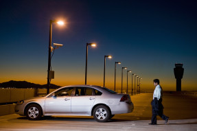 Businessman walking to car in parking lot