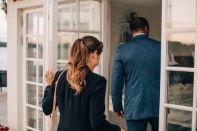 Agent and client entering a villa front door