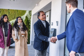 Agent shaking hand of client family member