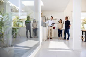 Agent showing clients the kitchen in a home