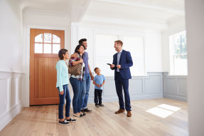 Agent showing empty home to a family