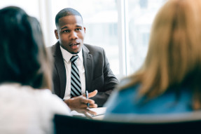 Agent speaking to clients in an office