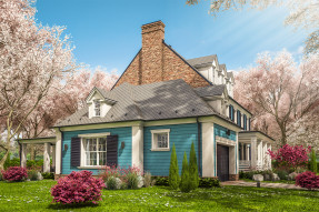 Blue and white house with cherry and azalea blossoms in the yard