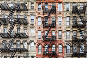 Brick apartment buildings with fire escapes