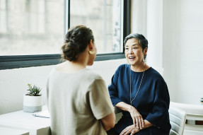 Business mentor and mentee talking in an office