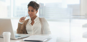 Businesswoman using laptop in office