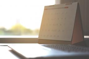 Calendar with laptop computer by window