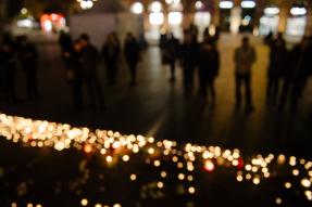 People near mourning candles