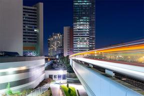 Commercial office buildings and commuter train at night