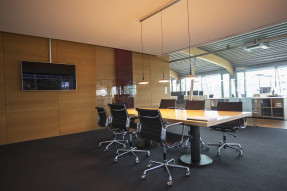 Conference room with TV on wood paneled wall