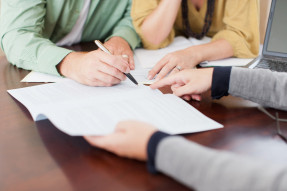 Couple signing a contract