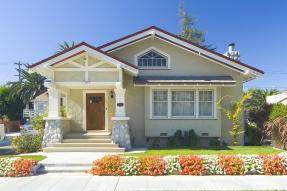 Craftsman house with red and white flowers