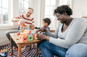 Family playing with child and enjoying their new home