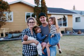 Family with young children outside home