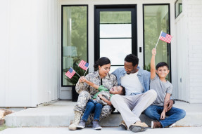 Female soldier excited to be reunited with her family in the doorstep of their home