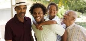 Four generations of men standing on a porch