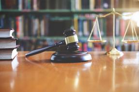 Gavel, scales, and books on a table