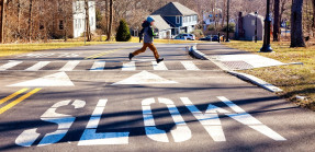 Kid crossing street in residential neighborhood