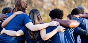 Friends linking arms in unity