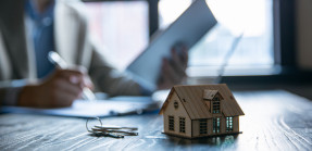 Model house and keys on desk