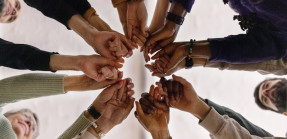 People fist-bumping during support group session