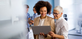 Young and old businesswomen working together