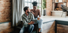 Couple looking at tablet in home