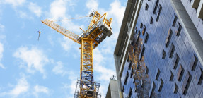 Construction crane next to high-rise building