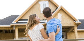 couple admiring house under construction