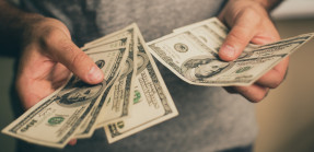 Man holding dollar bills in his hands