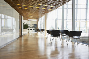 Groups of chairs next to glass wall outside office cafeteria