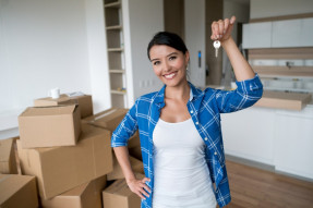 Happy woman holding keys to her new house