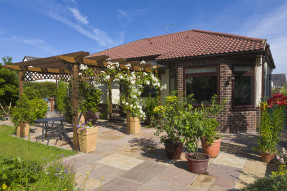 House with patio and Spanish tile roof