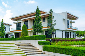 Large modern house with balconies and landscaped terraced front yard