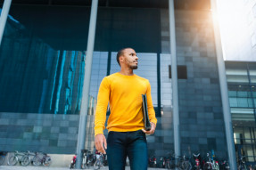 Young man with file wearing yellow pullover