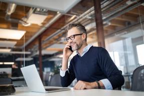 Man on phone at laptop