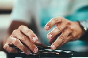 Man putting a card in a wallet