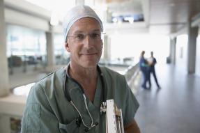 Medical professional wearing scrubs and a stethoscope