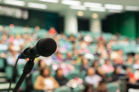 Microphone with convention attendees in the background