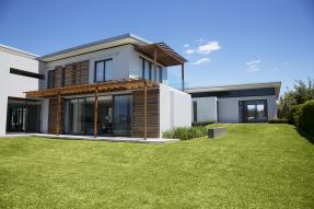 White modern house with a big lawn